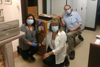 Hall Health staff with donations of PPE from international Huskies