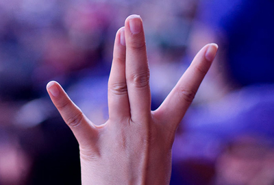A person making the "Dubs up" gesture with their hand