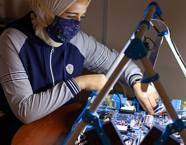 Rania Hussein working on a circuit board