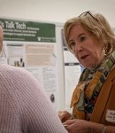 Person talking in front of a poster