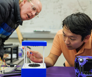 Josh Smith and Jared Nakahara working with acoustic levitation system. 