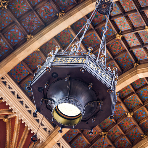 chandelier with bright ceiling tiles in the background