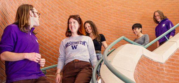 Undergraduate students walking down the stairs at the UW Planetarium.