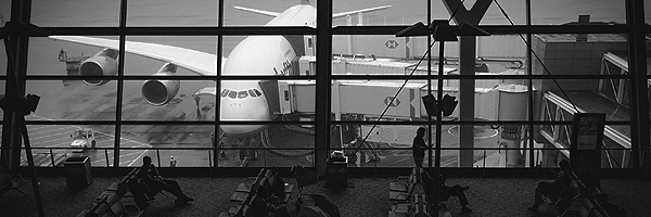 Airport waiting area with an airplane in the background.