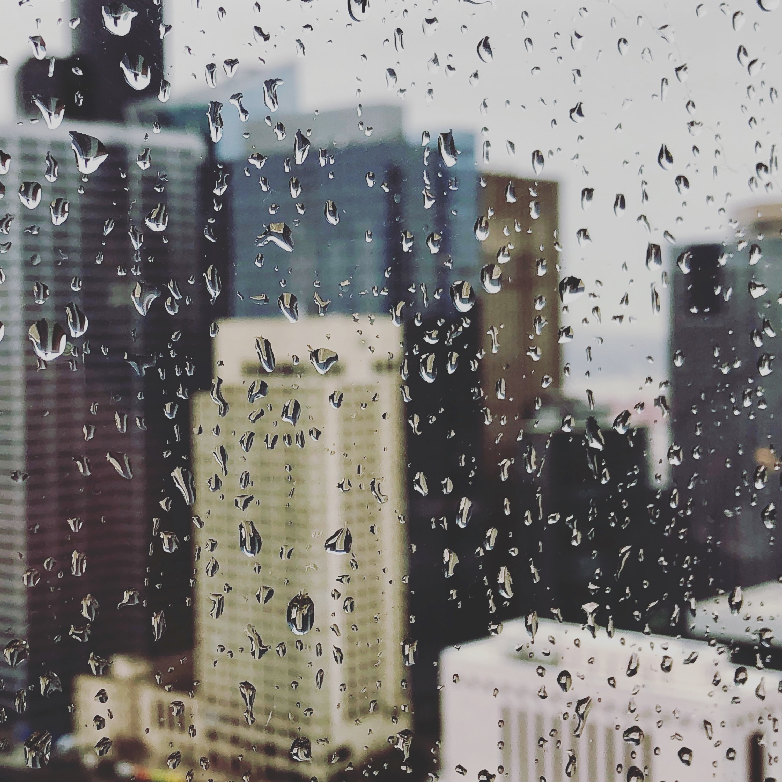 Rain on a window overlooking the Seattle downtown skyline