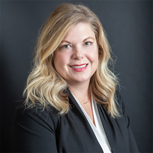 Professional headshot of Lisa Johnson, a woman with blond hair and a dark suit coat