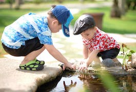 Two young boys by stream