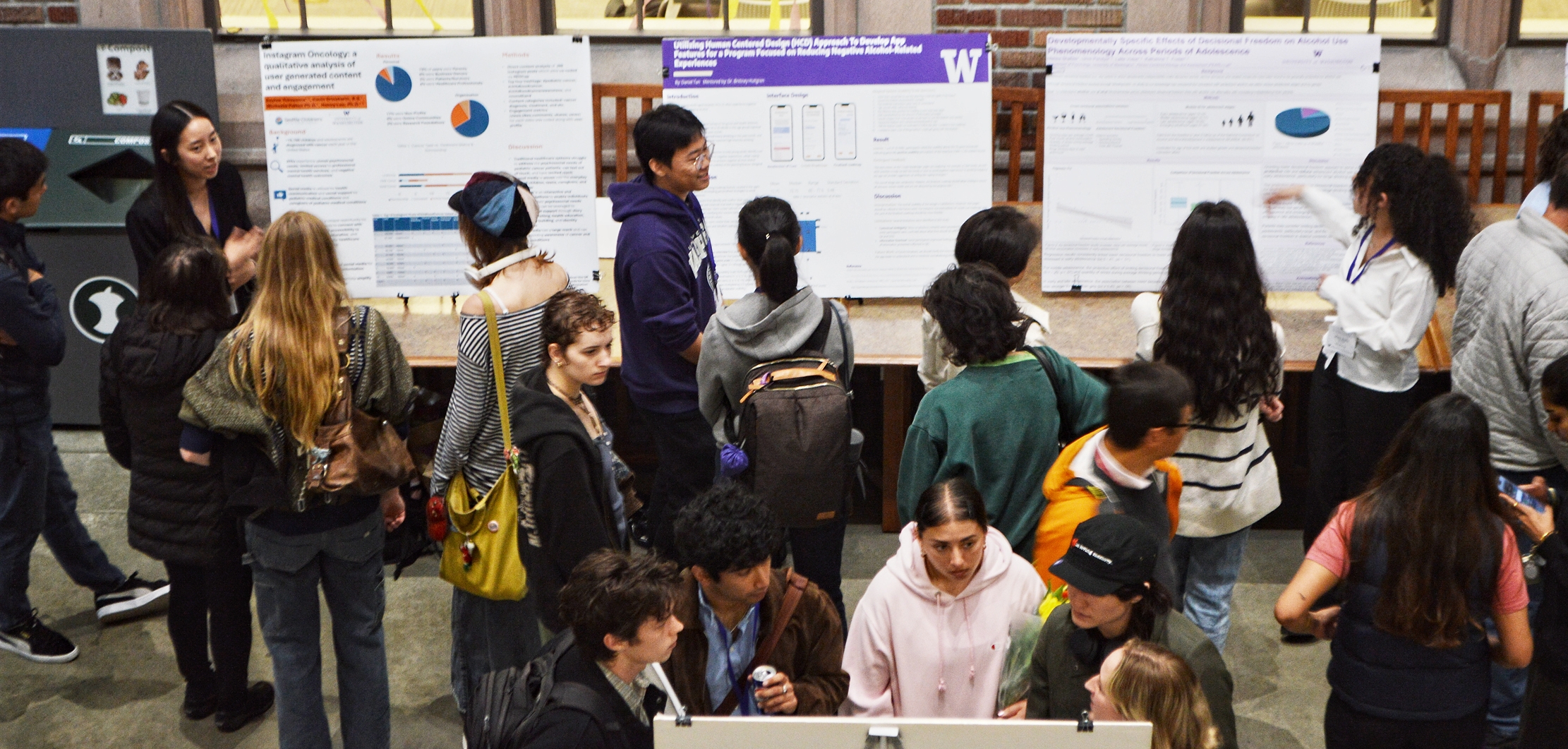 People at a conference looking at posters.