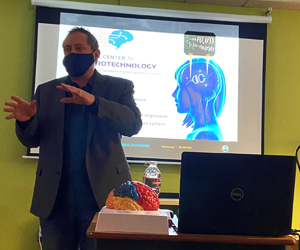 Scott Ransom giving a presentation at the front of a classroom during Brain Awareness Week