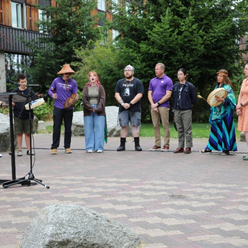 Members of UW Canoe Family sing a welcome song at the ceremony